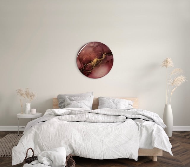 Round abstract wall art for the home. A symbol of transformation on a bedroom wall, inspired by the mythical fire bird and tarot death meaning. Rich warm colours of burgundy and gold, representing lightning, are the core features of this art piece of 10 inches by Inkandescent Arts.