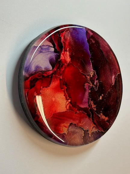 Small paintings in the form of abstract artwork. Round art in garnet and ruby with metallic striations. This abstraction would go beautifully on neutral toned walls.