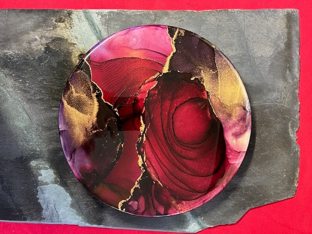 Tarot death meaning in round wall art - an original abstract of gold, black and red with life and death symbolism. An energetic, bold art piece of survival and growth by Inkandescent Arts.