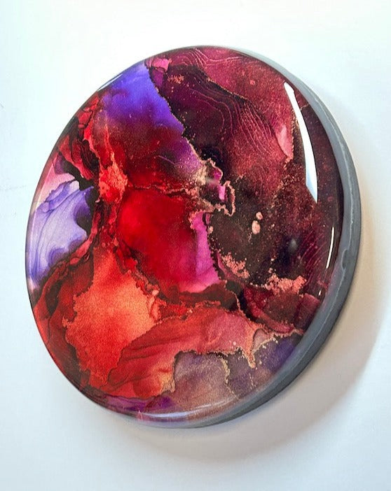 Aura themed - the fuel of the light within. - Interior abstract fluid art. Fluid tones of red, violet and maroon flow and overlap in this resin art painting. Striations of copper peek out depending on where the light hits. Interior wall art by Inkandescent Arts.