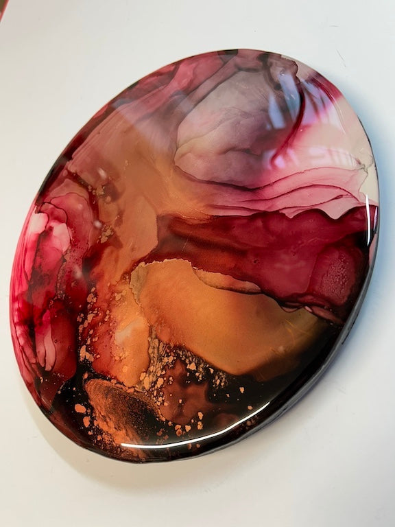 EMERGENCE - A fluid, abstract design 10’ Round, wall art painting. Representing a Mothers love, womb power and maternal instinct. With an infusion of wine and copper covered in resin, which gives it that beautiful, lustrous depth, shine and protection. Suffuse your wall with colour. By Inkandescent Arts. Resin abstract wallart.