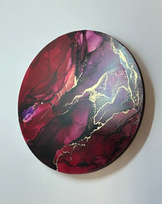 Red and violet hues dominate ‘Rebellion,’ an original, circular abstract wall painting for interiors. Brass ink fractures fork out atop the warm tones. By Inkandescent Arts Original matt purple and red abstract wall art expression. Abstract WALL ART ROUND in red and purple ink.