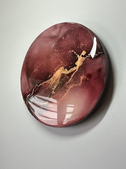 A circular contemporary abstract art piece that features maroon, red and gold. Original interior art symbolism painting.