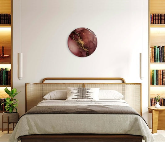 Circular abstract bedroom art hung over a bed featuring maroon, black and gold  lightning - a symbol of rebirth, life and death, and the duality of the Phoenix rising -  Meaningful wall art by Inkandescent Arts.