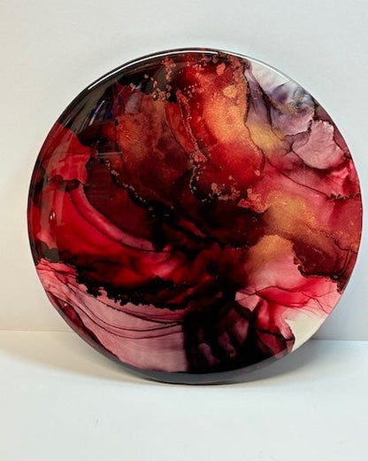 Contemporary art design of fiery red gold and black, this round art piece symbolises the phoenix rising.