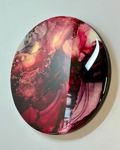 Round decorative abstract wall art featuring red black and gold.