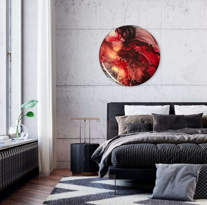 Bedroom wall art adorns a wall above a black bed - round art, 10 inches in size, features red, black, gold and copper for your home interior. 
Fiery abstract artwork with rebirth symbolism at its core. Would go beautifully in light and dark rooms adding a touch of warmth, energy and emotion by Inkandescent Arts.