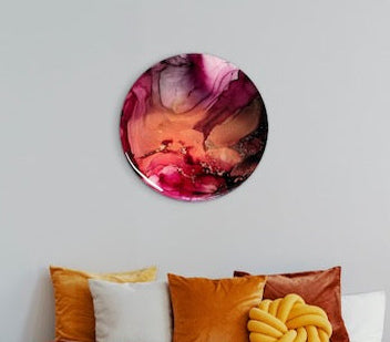 Circle art displayed over pillows in a warm toned room. Contemporary, cosy room decor that represents endings and beginnings.