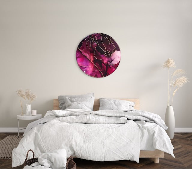 A round, contemporary painting of 10 inches hangs over a double bed - Transformation symbolism featuring deep red and copper this bedroom wall art decor would be perfect to brighten up your interior room.