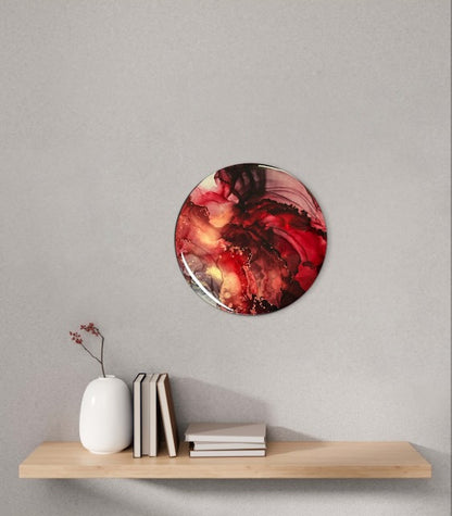 A round contemporary hallway art piece on a wall above a shelf - modern interior decor featuring crimson and gold full of warm tones and a vibrant atmosphere.