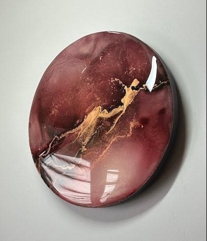 Contemporary abstract art at an angle - a closer shot displaying features of maroon and metallic gold. Original interior art - a symbol of shed blood and vitality based on the fire phoenix and the tarot death card in psychic readings - Rebirth and transformation by Inkandescent Arts.