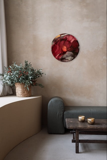 Red artwork on a living room wall, above a plant and a sofa. Transformative art that speaks of our emotional resilience as we go through our challenges in life. Connected to the Phoenix fire bird and arcana death card it is a reminder that we can bounce back when times are tough and move on to the next stage in life. Art by Inkandescent Arts.