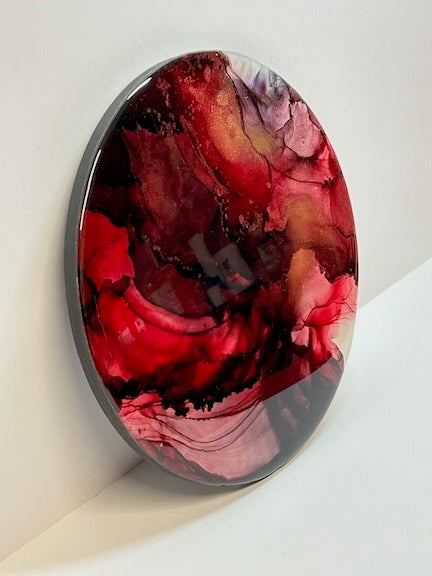 Vivid and dynamic coloured  abstract phoenix symbolism. Round resin art.