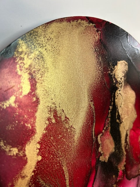 Healing art, transformation art, and a symbol that represents rebirth shown detail, angled view in bold red, gold and black texture.  Revolves around the death card meaning by Inkandescent Arts.