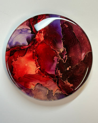 Resin wall art - An abstract, artwork painting of inks. Fiery, bold blends of deep red, black with the odd splice of purple.  Rivers of metallic brass erupt throughout. Dark tones accentuate the metallic striations.   Life force themed, Planes Of Passion is a modern, abstract, wall ornament by Inkandescent Arts.