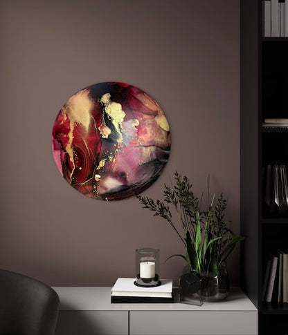 Life and death symbolism art adorns an office wall over a desk. Original and modern abstract wall art of red, crimson, carbon and rich gold colours portraying a symbol of renewal in round art by Inkandescent Arts.
