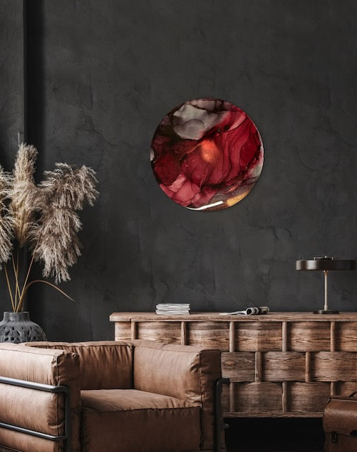 Small luxury art of maroon and burgundy  red displayed on a dark interior wall . This modern living room decor of mystical symbolism is based on the Phoenix rising. Artwork by Inakdescent Arts.