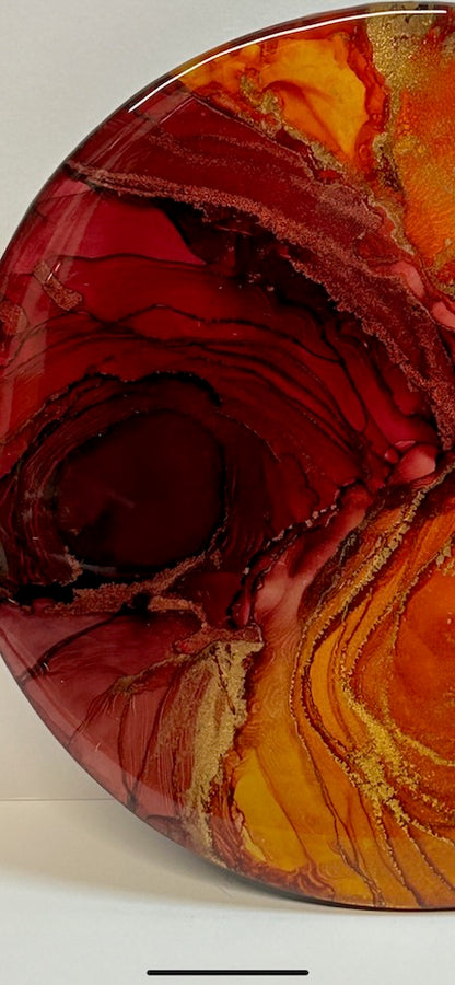 Close-up of a red and orange painting with lines and spirals. Modern abstract art of rich colours on a white background. A fantasy abstract of the mystical fire bird and art symbolism art of rebirth and regeneration.