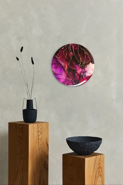 Modern wall art adorns a wall over ornaments on wooden plinths. Depth filled art in maroon red and copper leaf lines it explores themes of rebirth symbolism and major changes. Abstract painting by Inkandescent Arts.
