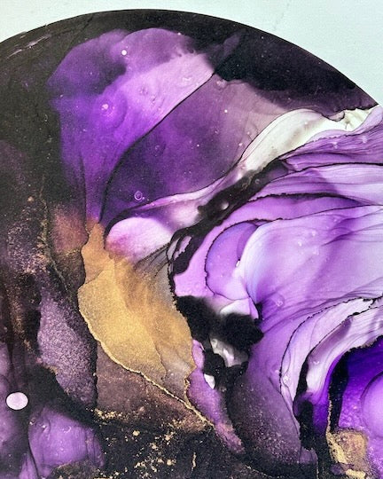 Abstract art with swirling purple, black, and gold colors.