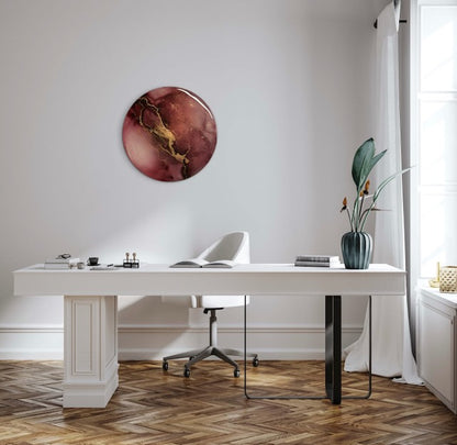 Original office wall art above a chair and desk. This round abstract painting features warm burgundy and gold colours and is a symbol of endings and beginnings - Phoenix based art by Inkandescent Arts.