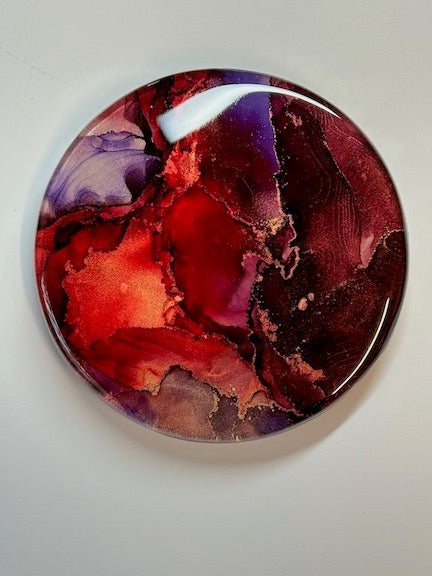 Small living room decor ideas: mini paintings in fiery deep red, black and purple where rivers of metallic brass erupt throughout. Dark tones accentuate the metallic striations.
