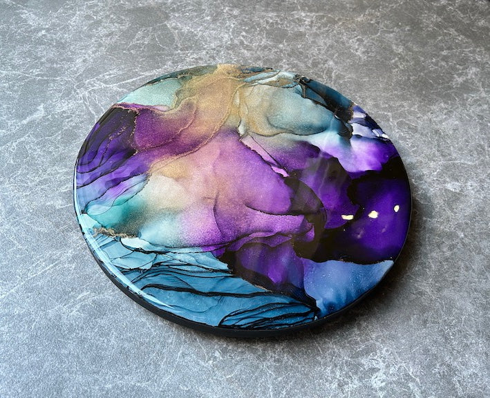 PSYCHE is a round, resin abstract painting of ethereal otherworldly portals.
Embodying the tales of the mortal Psyche, the wrath of the Goddess Aphrodite and her final trial into the underworld - PYSCHE represents a test of her resolve, commitment and love - and the soul of Psyche on her journey through the underworld. 

A story of forbidden love.
By Inkandescent Arts.
