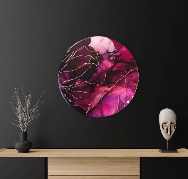 Transformation symbol featuring deep red jewel tones and mystical purple on a dark wall above a cabinet.  Based on the death tarot card and phoenix of myth, this round wall art represents rising from ashes of a major change. Cozy room painting by Inkandescent Arts
