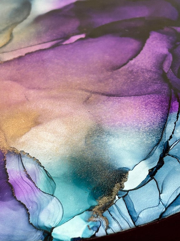 A timeless, round and elegant abstract of wildflower colours and a dreamy aesthetic. Mystical and moody, agate and violet shimmer with ethereal qualities, radiance and beauty.  Coated in multiple layers of resin giving that glossy, mirror like shine.

A mesmerising abstraction of ancient doorways and paths into and out of the underworld by Inkandescent Arts.
