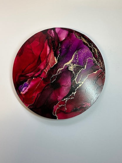 Room decoration of plum and garnet, together with brass create this circular painting. Rich and powerful art for your interior.
