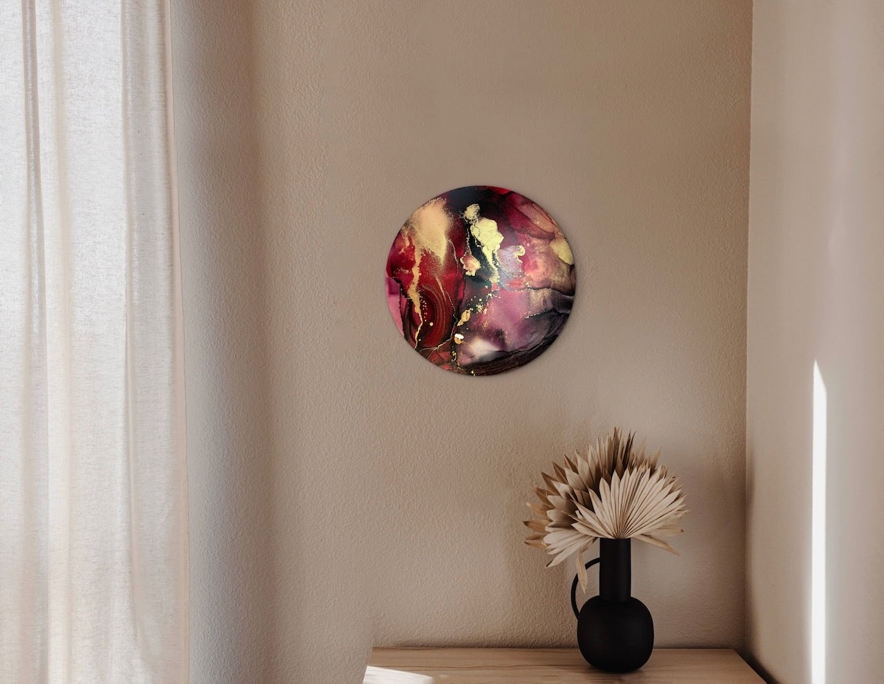 Phoenix symbolism of rebirth on a circular abstraction adorning a neutral wall in a bedroom with dark ornaments beneath on a cabinet. Wall decor which will help create a warm and cosy ambience to your room. 