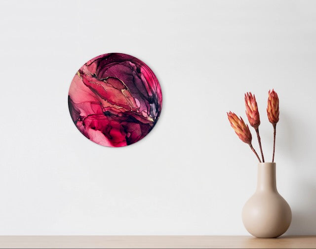 Red abstract wall art decor, with real 23 carat gold leaf, hung up on a wall above a shelf with a vase and dried flowers. Enhance your space with vibrant colour and a positive outlook with this elegant painting. Perfect for a loft, office, study or living room.