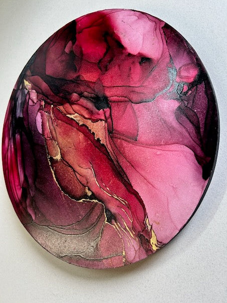 Contemporary art in a round abstract design featuring burgundy, red, and 23k gold leaf - a symbol of strength, rebirth and renewal based on the death tarot meaning and mythical phoenix by Inkandescent Arts.