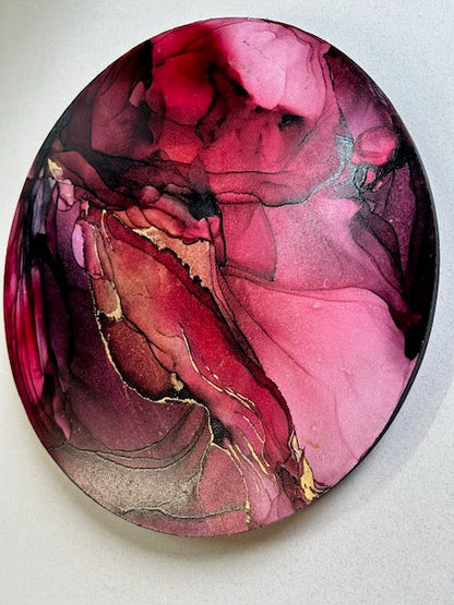 Contemporary art in a round abstract design featuring burgundy, red, and 23k gold leaf - a symbol of strength, rebirth and renewal based on the death tarot meaning and mythical phoenix by Inkandescent Arts.