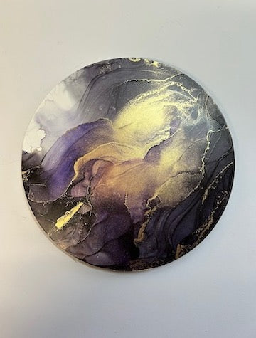 Circular wall art. A modern, original, surreal wall art abstraction.
An ethereal, metaphysical fluid ink painting of slate, purple and black where gold floods the surface, giving the painting a magical dreamscape appearance. Contrasting with the moody and stormy appearance of sea and sky. Eerily beautiful and atmospheric.