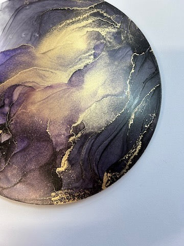 Abstract art piece with purple, gold, and black colors on a white background