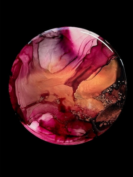 A round painting on a black wall showing  the striking, rich colour of copper, wine and black contrasting colour. Representing a major change, rebirth and transformation by Inkandescent Arts.